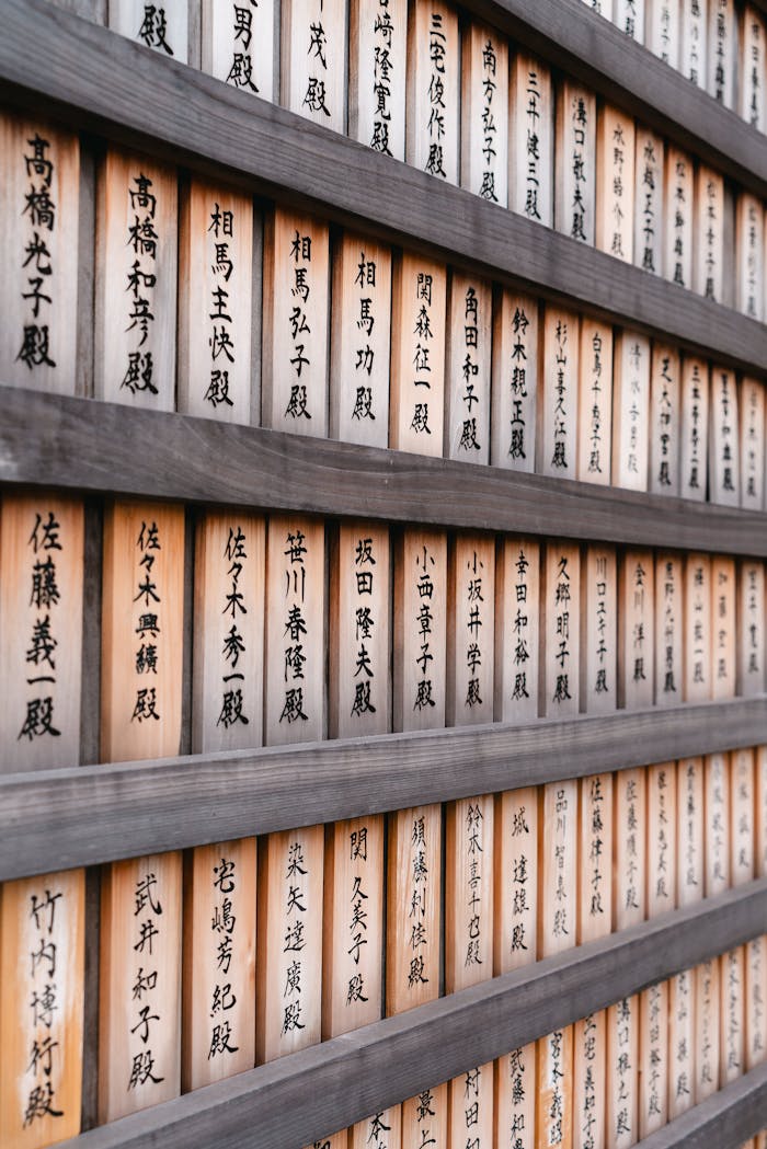 Home Wall of wooden panels with Kanji at a Japanese temple, showcasing cultural tradition.