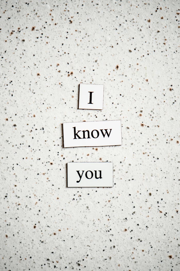 Services Elegant paper cutout letters spelling 'I know you' on speckled granite.